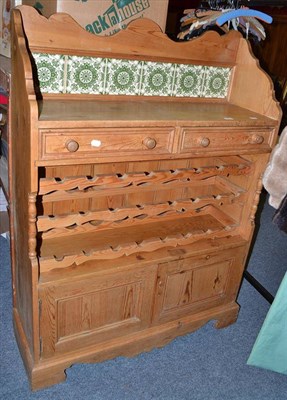 Lot 688 - Pine kitchen cabinet with wine rack to the middle and tile back