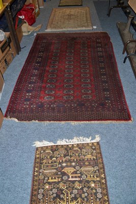 Lot 702 - Bukhara rug, Lahore, Punjab, the claret field with three columns of quartered guls enclosed by...