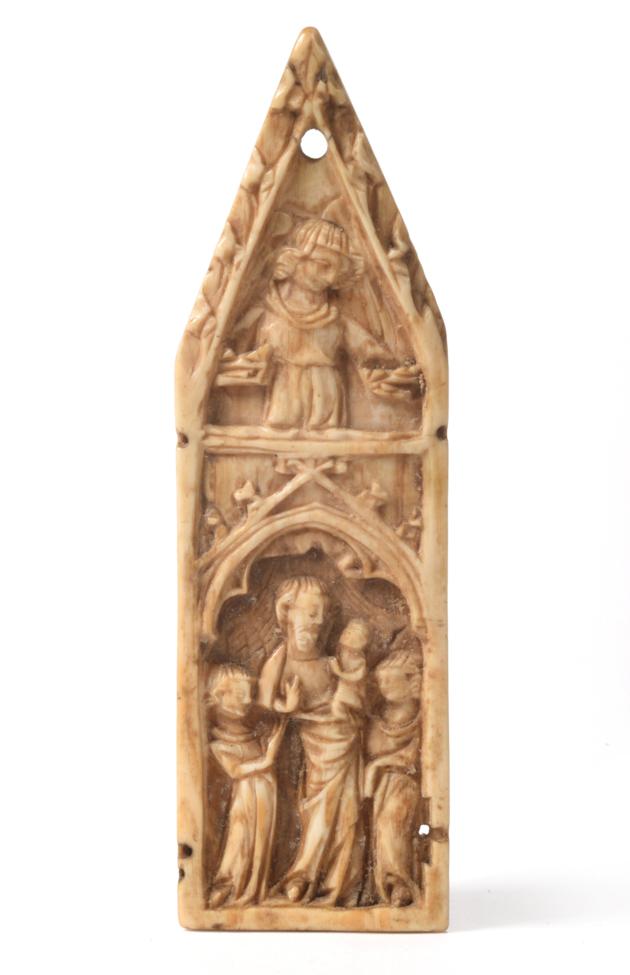 Lot 801 - An Ivory Plaque, Northern French, 14th century, carved with the Madonna and Child flanked by...