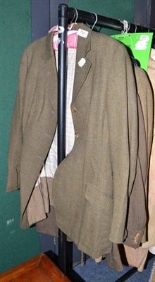 Lot 722 - A Moss Bros tweed jacket and two green tweed hacking jackets