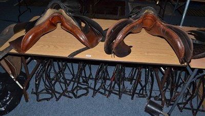 Lot 723 - Eight assorted leather saddles, two standing saddle stands and nineteen wall mounted saddle...