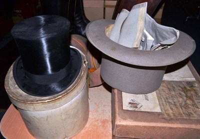 Lot 728 - Black silk top hat and a grey felt top hat with two pairs of chaps, both with card hat boxes