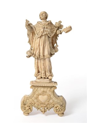 Lot 803 - An Ivory Figure of a Saint, probably South German, 17th century, wearing flowing robes standing...