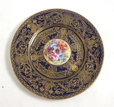 Lot 9 - A Royal Worcester plate, centre painted with flowers, Leemas