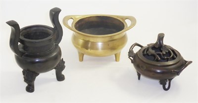 Lot 24 - A Chinese bronze tripod censer, another bronze censer with cover and an archaic style censer