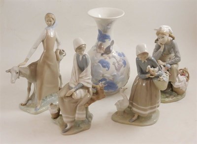 Lot 25 - A Lladro porcelain figure of a girl with a goat, a Lladro porcelain figure of a girl with a doll, a