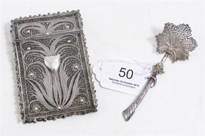 Lot 50 - A white metal filigree card case and white metal filigree spoon (2)