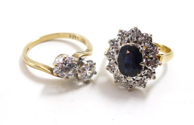 Lot 96 - An 18ct gold sapphire and diamond cluster ring and a 9ct gold cubic zirconia two stone ring (2)