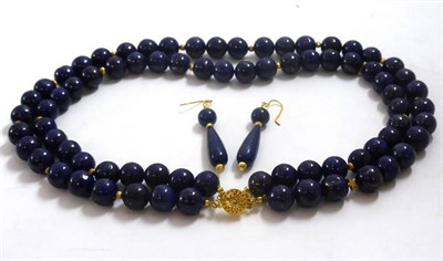 Lot 100 - A two row lapis lazuli necklace and a pair of drop earrings