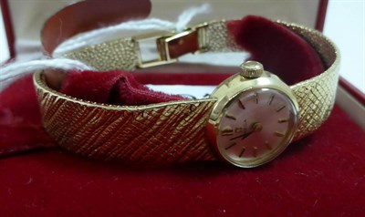 Lot 212 - A lady's 9ct gold wristwatch, signed Omega, circa 1965, lever movement, silvered dial with...