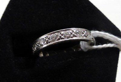 Lot 233 - A diamond eternity ring, round brilliant cut diamonds in white claw settings, with engraved...