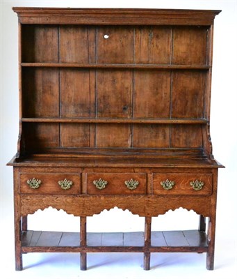 Lot 838 - A George III Oak Dresser and Rack, 3rd quarter 18th century, with a bold cornice above two shelves