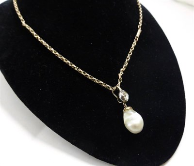 Lot 249 - A diamond and pearl pendant, a rose cut diamond in a white collet setting suspends a baroque pearl