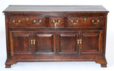 Lot 839 - A George III Oak and Mahogany Crossbanded Enclosed Dresser, late 18th century, with two long...