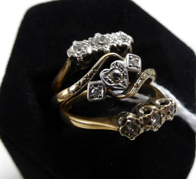 Lot 253 - A 9ct gold diamond three stone ring, and two other diamond three stone rings (3)