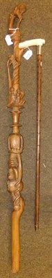 Lot 294 - An Edwardian Partridgewood walking stick with silver collar and ivory handle and a carved wood...