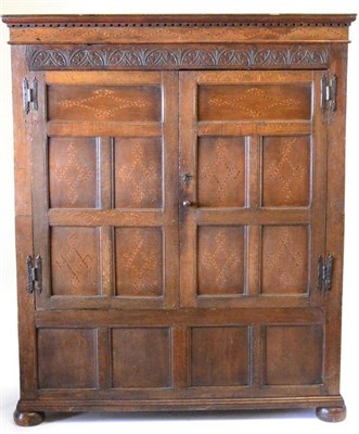 Lot 845 - An 18th Century Joined Oak Cupboard, the later dentil cornice above a lunette carved frieze and two