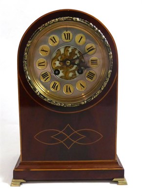 Lot 304 - A mahogany veneered and inlaid striking mantel clock