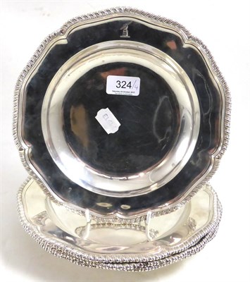 Lot 324 - A set of three George III silver soup plates, Andrew Fogelberg & Stephen Gilbert, London 1781,...