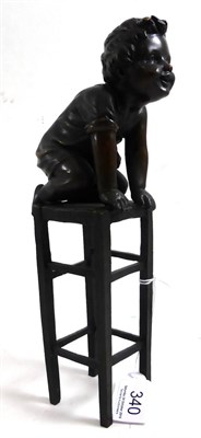 Lot 340 - A bronze figure of a child on a high stool