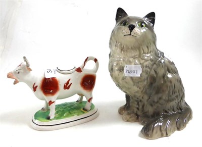 Lot 342 - A Royal Doulton cat and a Staffordshire cow creamer