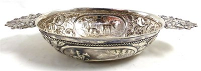 Lot 373 - A Dutch silver coloured metal tab handled oval porringer, Dutch lion mark