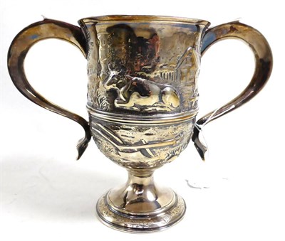 Lot 374 - A George III silver twin handled cup, London 1786, later decorated with cattle (erased crest)