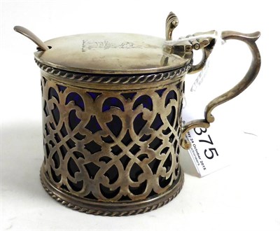 Lot 375 - A silver mustard engraved with a crest, with blue glass liner