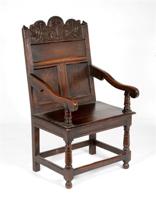 Lot 854 - A 17th Century Joined Oak Wainscot Armchair, with foliate carved top rail above three fielded...