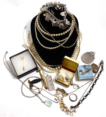 Lot 402 - A cultured pearl necklace, a silver charm bracelet, silver ingot and other jewellery