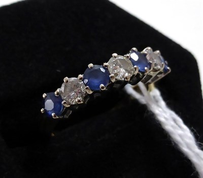 Lot 406 - An 18ct gold sapphire and diamond seven stone ring