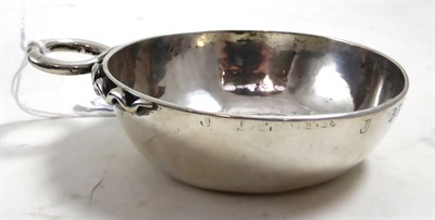 Lot 412 - A silver wine taster (worn and repaired)