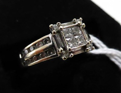 Lot 420 - A diamond cluster ring, stamped '750', and '0.80', one diamond baguette missing