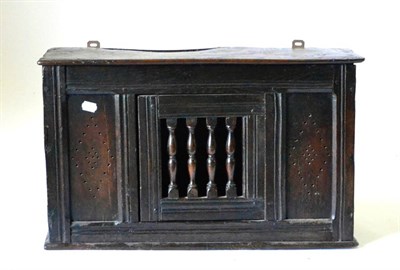 Lot 857 - An Early 18th Century Joined Oak Mural Livery Cupboard, with spindle turned hinged door, 70cm...