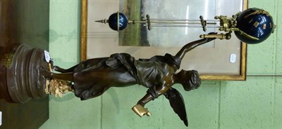 Lot 431 - A bronzed spelter mystery timepiece, early 20th century, winged figure holding a scroll and...