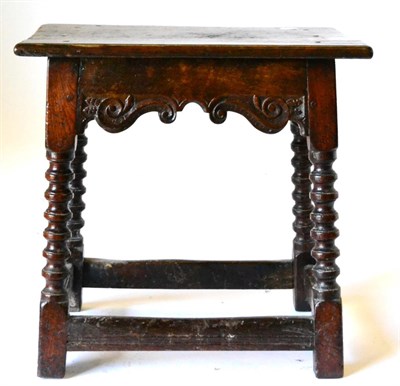 Lot 864 - An English Joined Oak Stool, circa 1650, the six-pegged rectangular top above an S shaped...