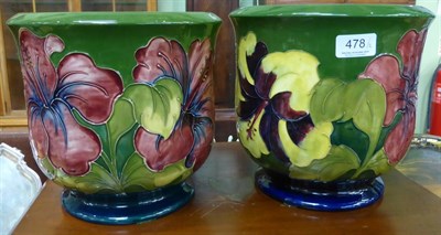 Lot 478 - Two Walter Moorcroft Hibiscus pattern planters, on green grounds, impressed factory marks,...