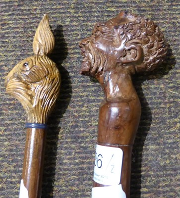 Lot 486 - An African chief's staff with carved head pommel and a swagger stick with pommel carved as a...