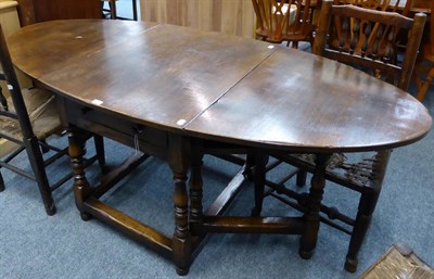 Lot 1010 - A Titchmarsh & Goodwin oak drop leaf table fitted with a drawer