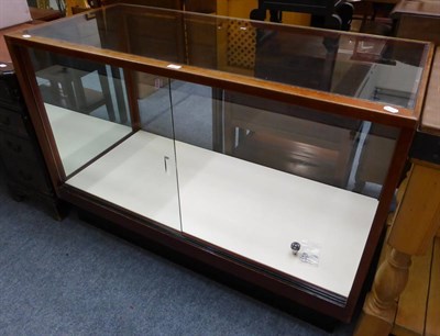 Lot 1025 - A glazed shop display cabinet