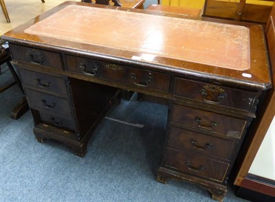 Lot 1026 - A pedestal desk inset with red leather