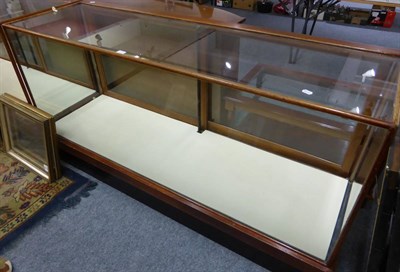 Lot 1039 - A glazed shop display cabinet