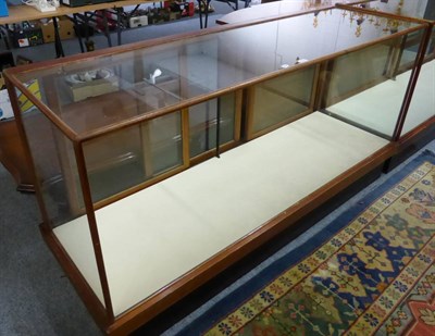 Lot 1040 - A glazed shop display cabinet