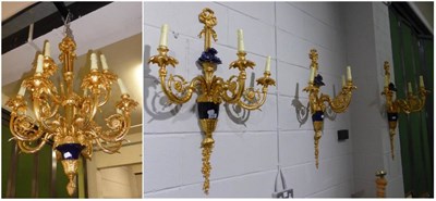 Lot 1062 - A period style twelve-light gilt metal chandelier with a set of three matching three-light wall...