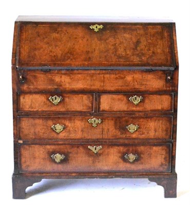 Lot 875 - A George II Walnut and Feather Banded Bureau, 2nd quarter 19th century, the fall enclosing a fitted