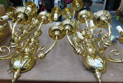 Lot 1083 - A pair of modern brass five-light wall lights