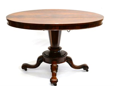 Lot 887 - A Victorian Rosewood Oval Loo Table, circa 1850, the flip-top raised on a tapering support with...