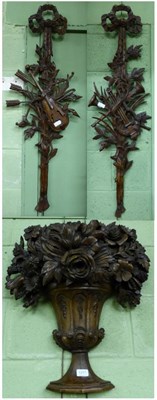 Lot 1217 - A group of three resin wall mounts including a floral urn and two ribbon tied musical trophies