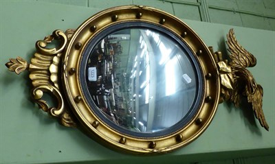 Lot 1223 - Regency style gilt framed convex wall mirror with eagle surmount