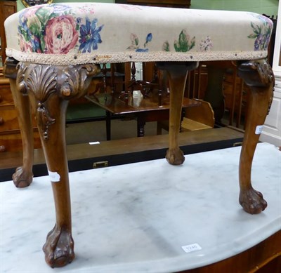 Lot 1247 - A Georgian style walnut dressing table stool, with ball and claw feet